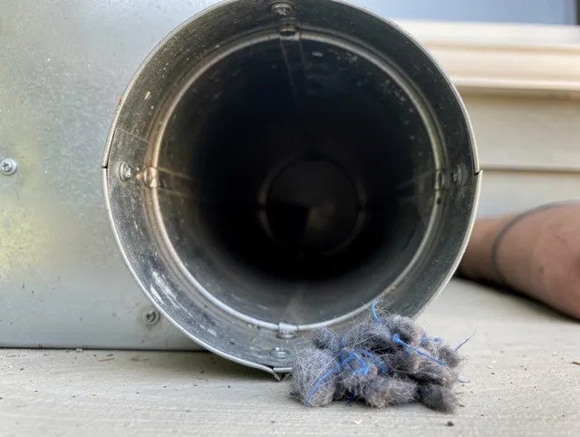 Carver Dryer Vent Cleaning technician using specialized equipment to clear severe dryer vent blockage in Carver